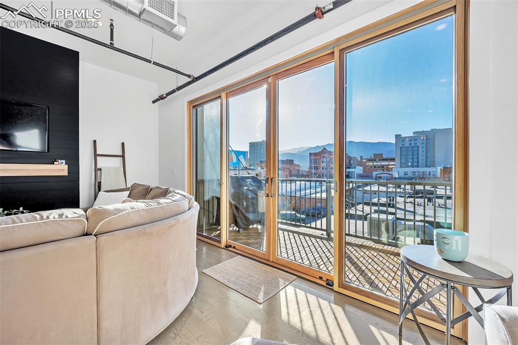 Image 29 of 48: Living room with a view of city and wood finished floors