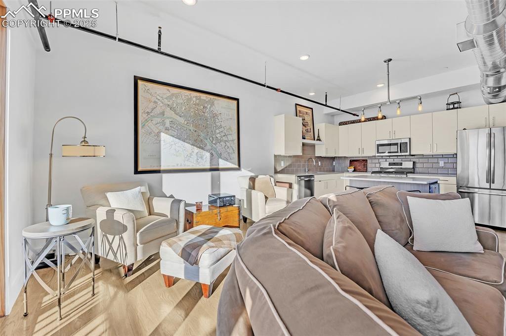 Image 31 of 48: Living area featuring light wood-type flooring and recessed lighting