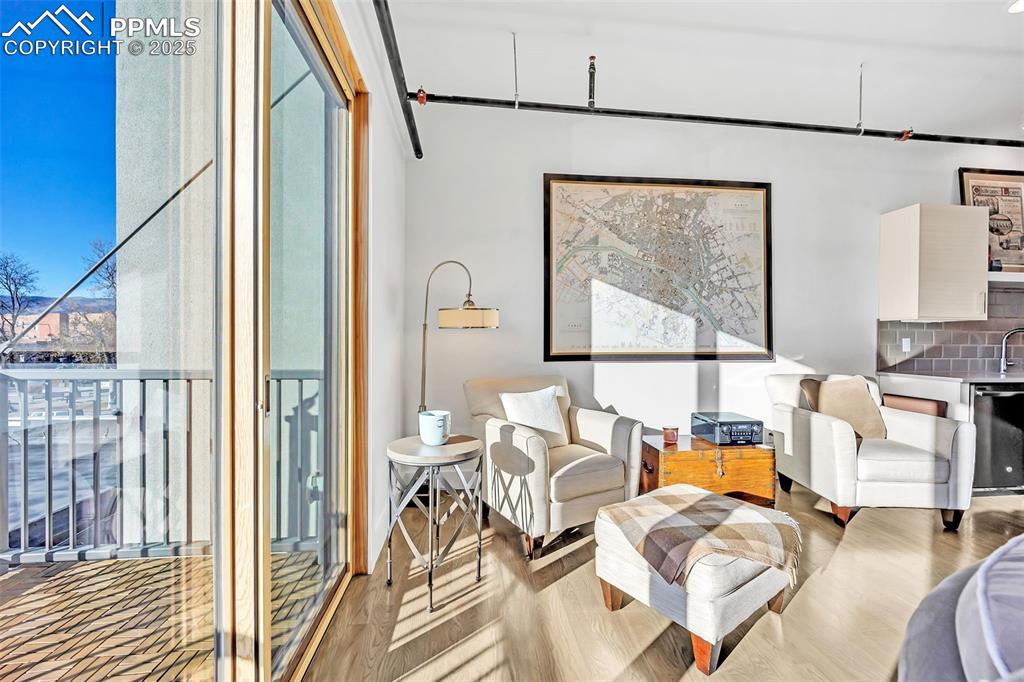 Image 32 of 48: Living area with light wood-style floors