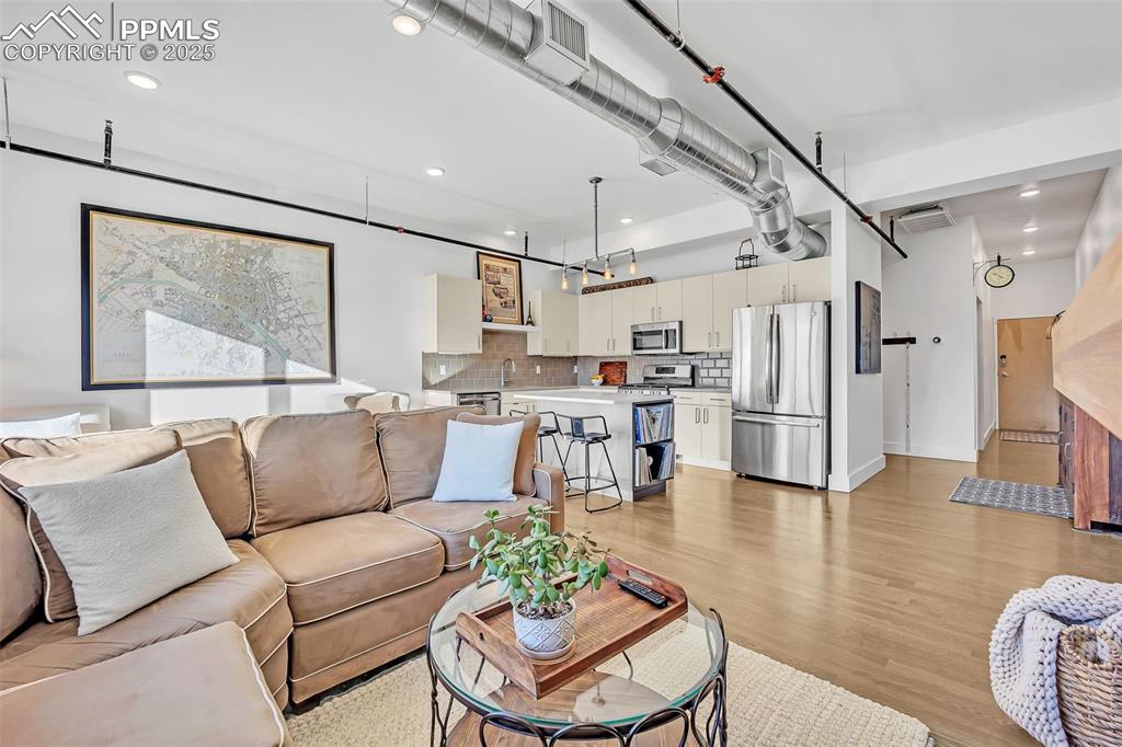 Image 33 of 48: Living room featuring recessed lighting, light wood-type flooring, visible