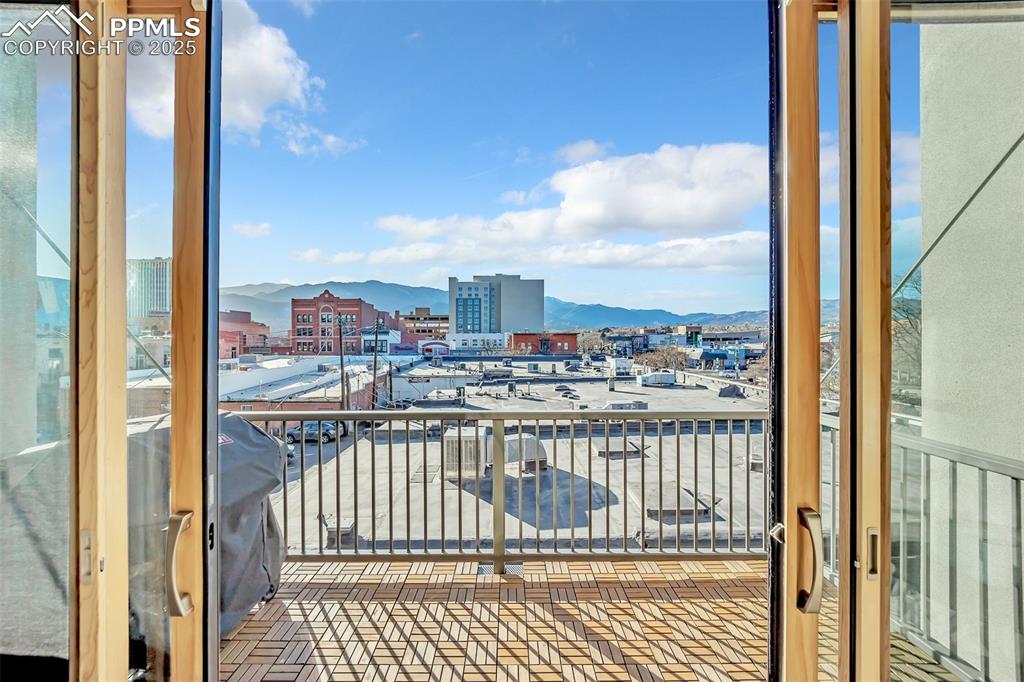 Image 36 of 48: Balcony featuring a mountain view and a city view