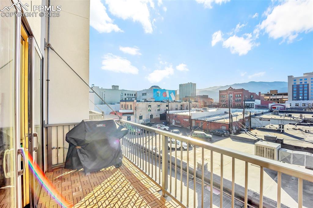 Image 37 of 48: Balcony with a grill, a mountain view, and a city view