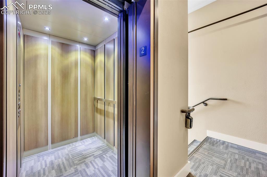 Image 39 of 48: Details with elevator, carpet flooring, and recessed lighting