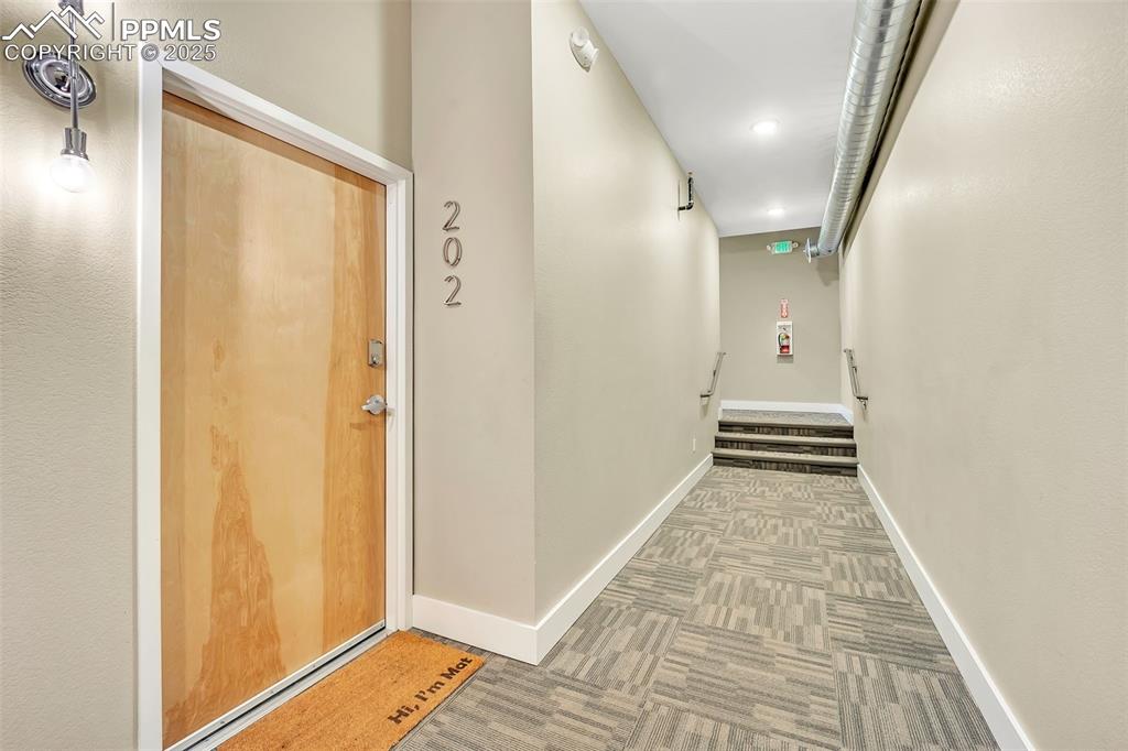 Image 7 of 48: Corridor with carpet floors, recessed lighting, and baseboards