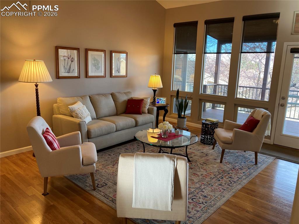 Image 3 of 12: Another view of the living room with vaulted ceilings and walk out to the b