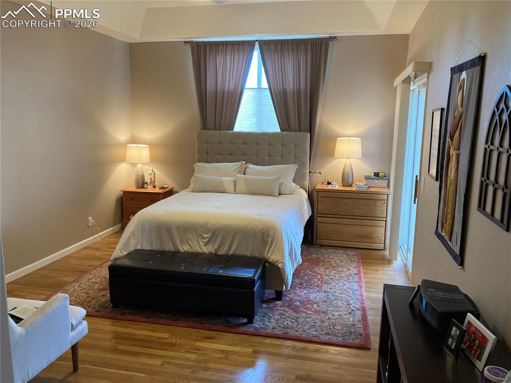 Image 5 of 12: The large primary bedroom features a walk out to the deck, walk-in closet a