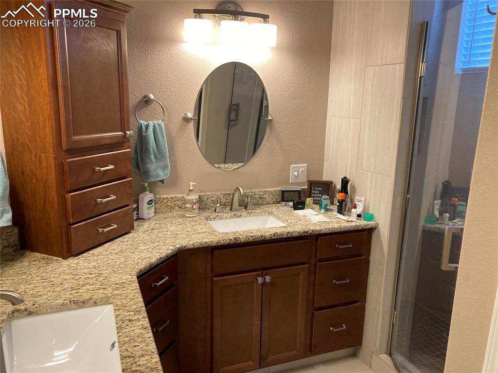 Image 6 of 12: The primary bath has a beautiful walk in shower, double sinks, and a heated
