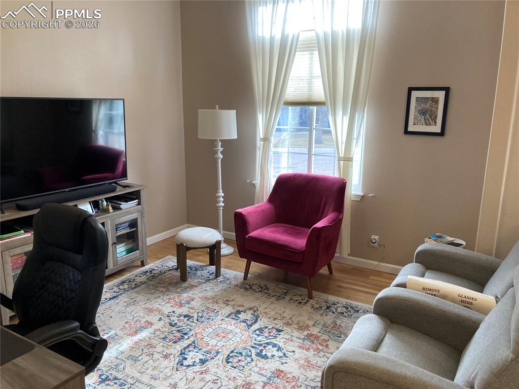 Image 7 of 12: The two smaller bedrooms on the main level have been converted into one lar