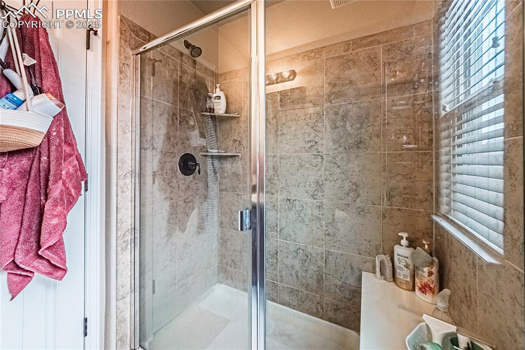 Image 17 of 36: Full bathroom featuring a shower stall