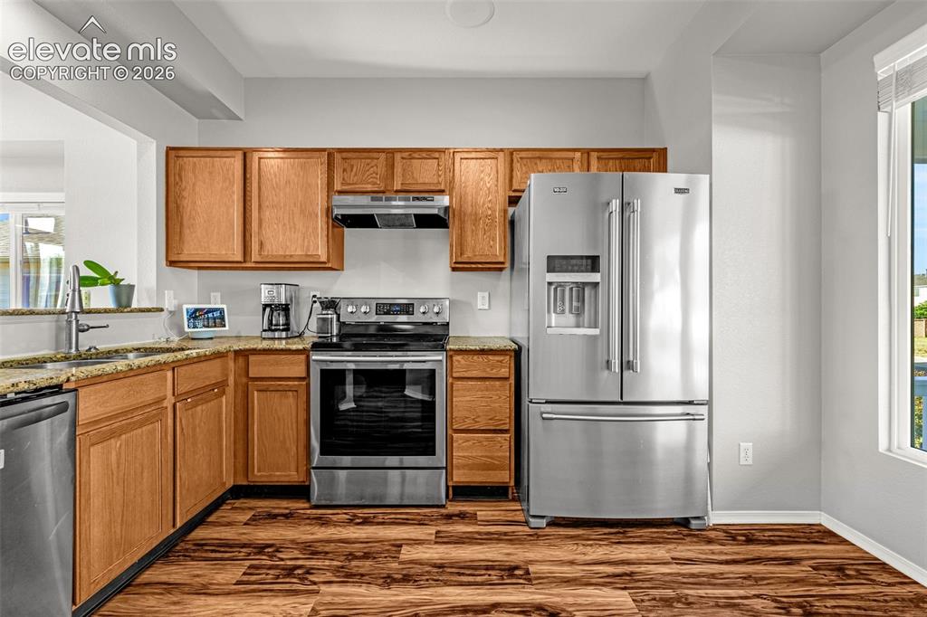 Image 10 of 42: Kitchen featuring wood-finish flooring, light wood cabinetry, and stainless