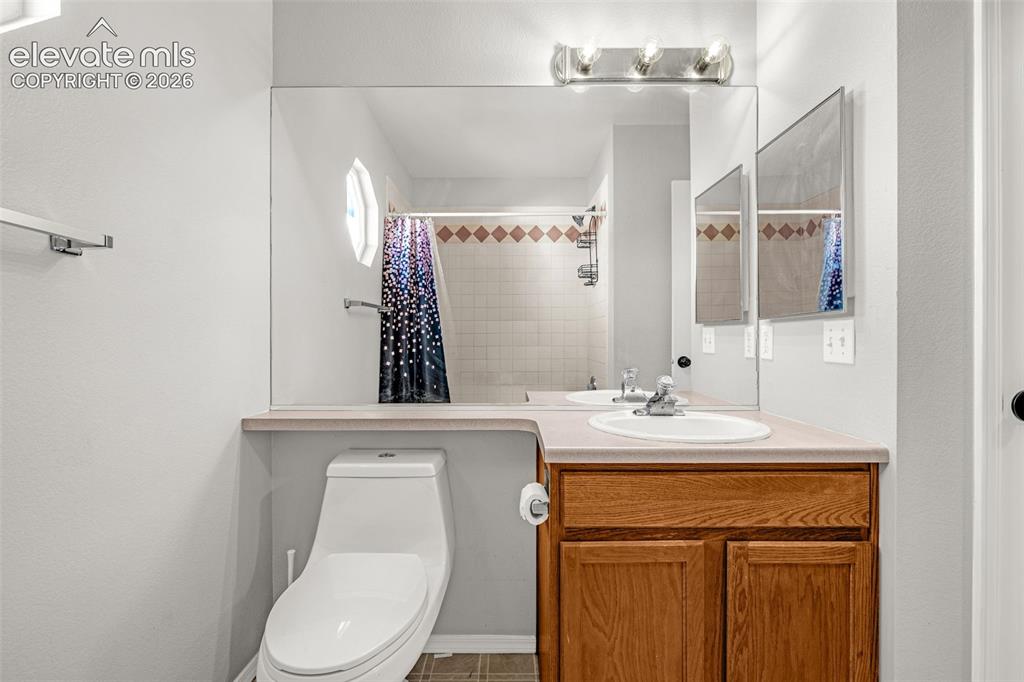 Image 13 of 42: Bathroom with a single vanity featuring a laminate countertop, integrated s
