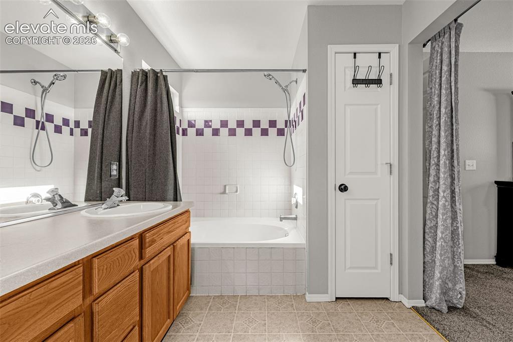 Image 18 of 42: Bathroom featuring a wood-finish vanity with an integrated sink, a built-in