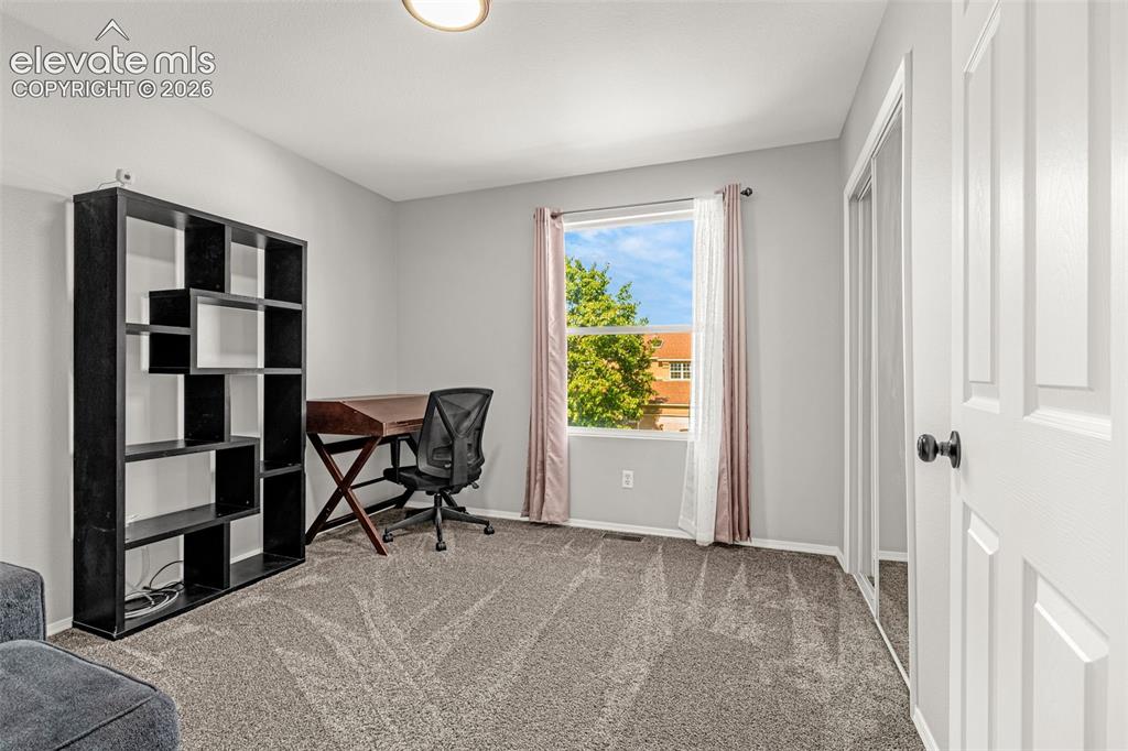 Image 20 of 42: Carpeted interior space with a window, white trim, and a white paneled door