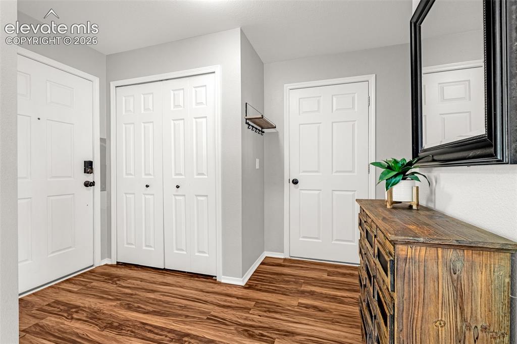 Image 5 of 42: Entryway featuring wood-finish flooring, light gray walls, white trim, and