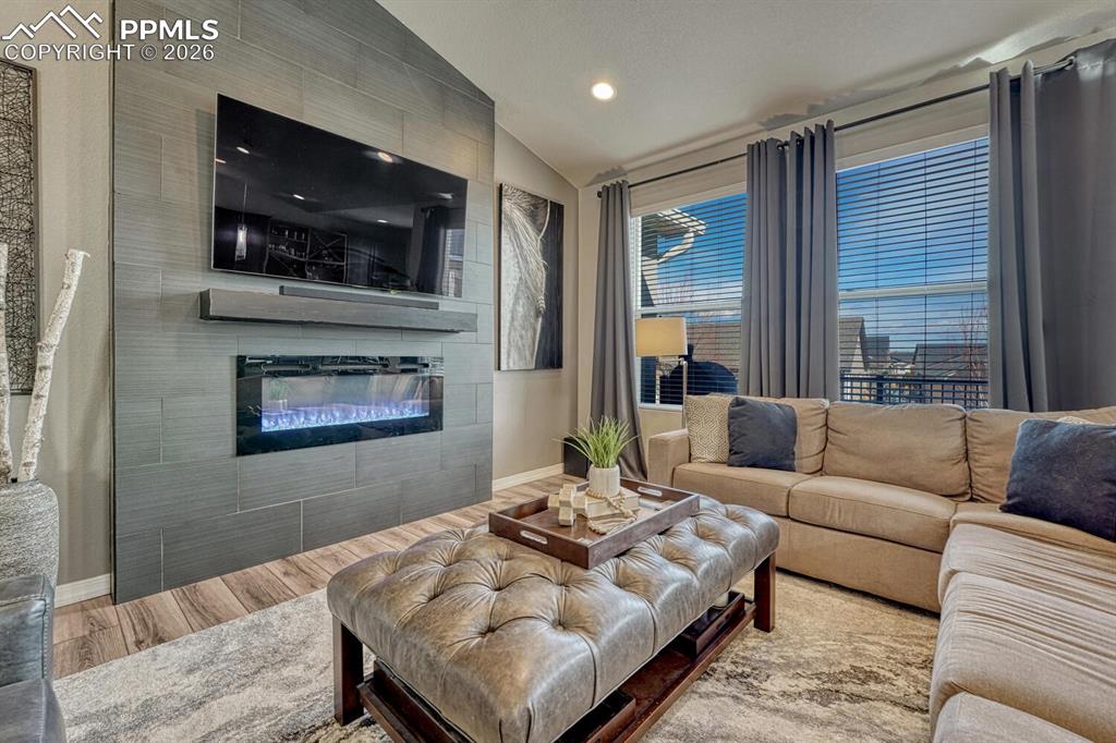 Image 18 of 50: Custom electric fireplace with Italian tile surround to cozy up on chilly C