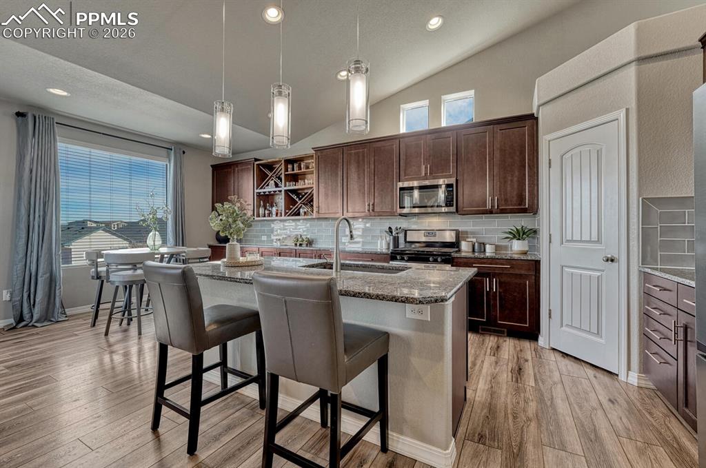 Image 19 of 50: Breakfast bar with pendant lights.