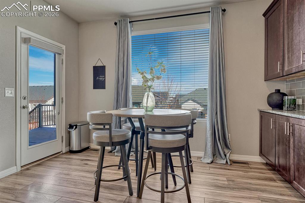 Image 21 of 50: Walk out from the Dining Nook to the backyard composite deck.