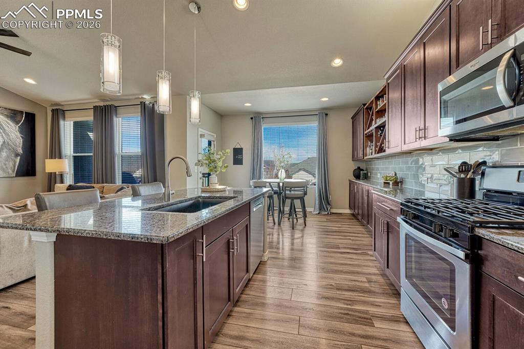 Image 24 of 50: View of the Breakfast Nook from the Island Kitchen.