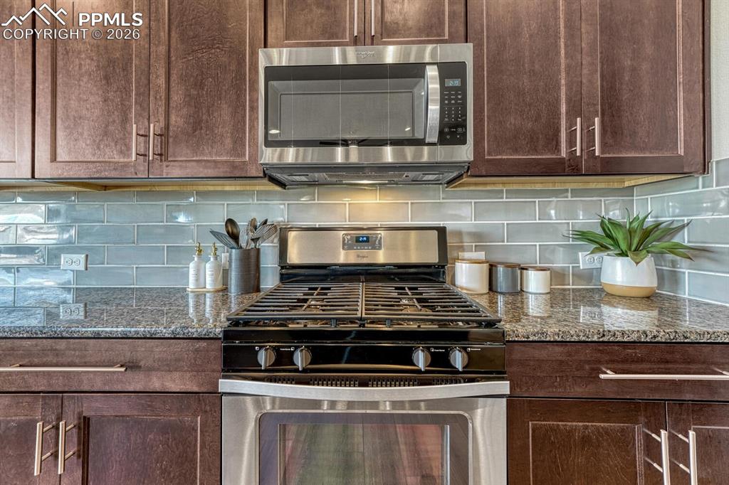 Image 25 of 50: Stainless Steel Appliances include a gas range oven, built-in microwave, di