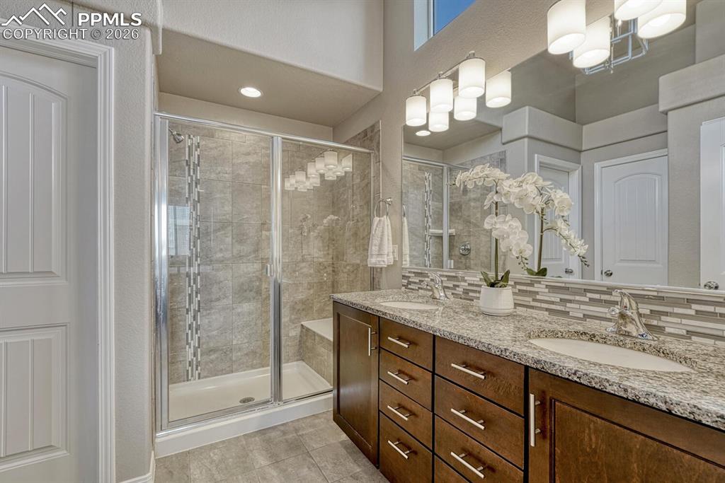 Image 29 of 50: Spa-Like Shower Bathroom in the Primary Bedroom includes a dual sink comfor