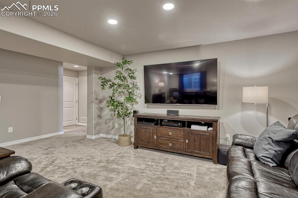 Image 34 of 50: Spacious Family Rec Room with neutral carpet and space for a TV area, game 