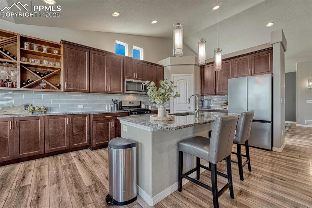 Image 4 of 50: The Gourmet Island Kitchen features a breakfast bar, pendant lights, pantry