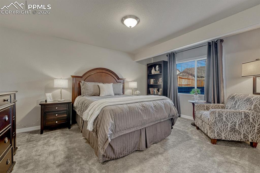 Image 40 of 50: Basement Bedroom #3 with neutral carpet.