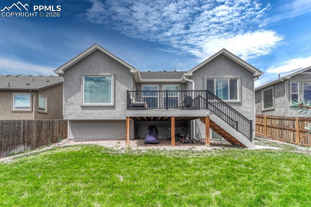 Image 7 of 50: Fenced 0.13 acre lot with composite deck to enjoy the beautiful Peak views 