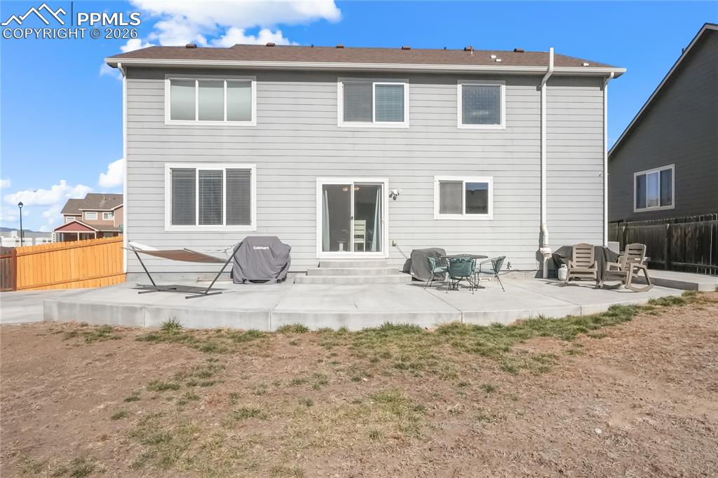 Image 20 of 25: Massive concrete patio for summer BBQ