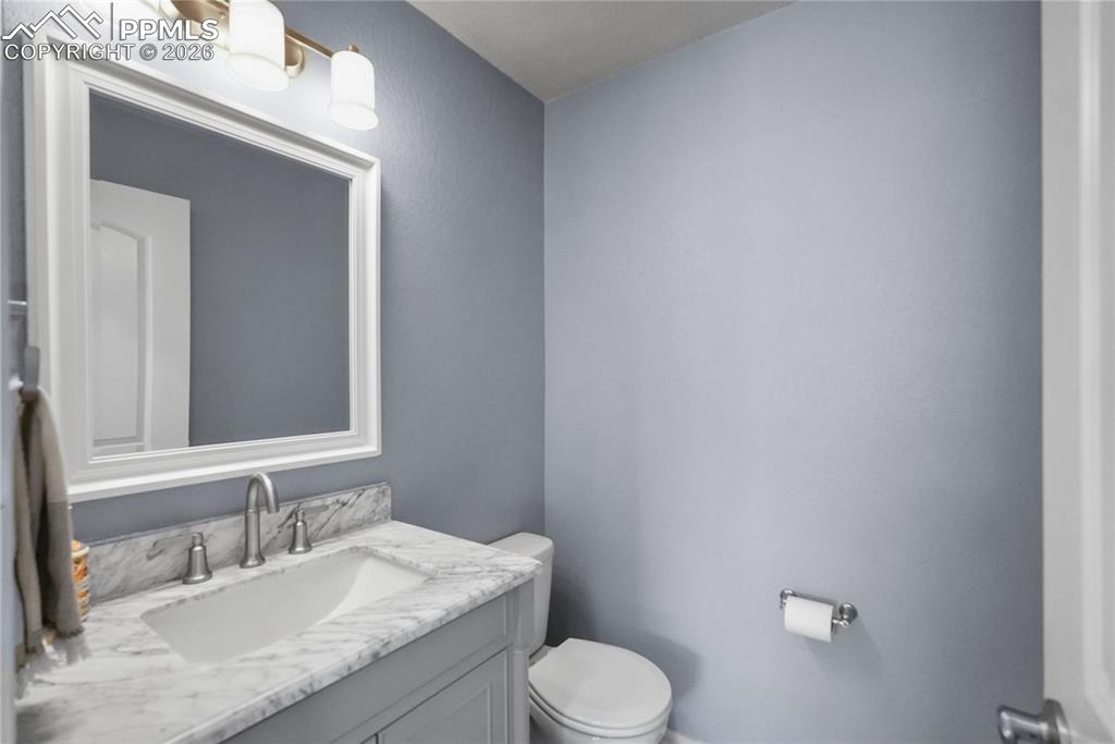 Image 22 of 25: Hallway half bathroom.