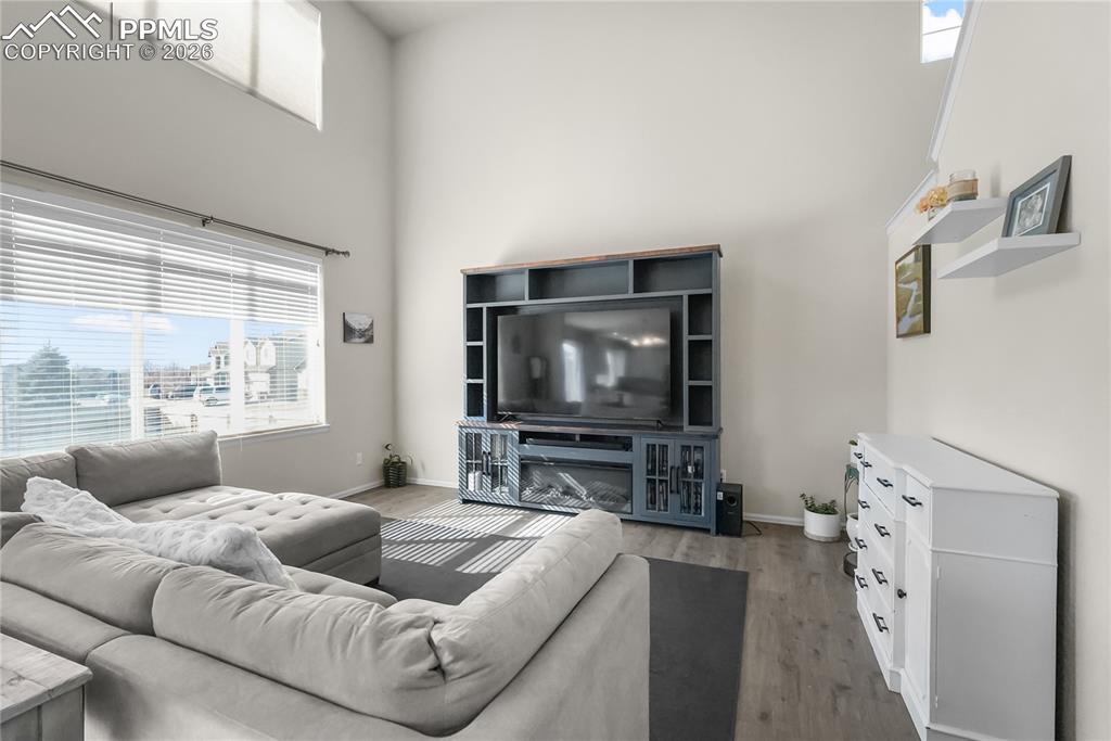 Image 7 of 25: Living room with vaulted ceilings and natural light.