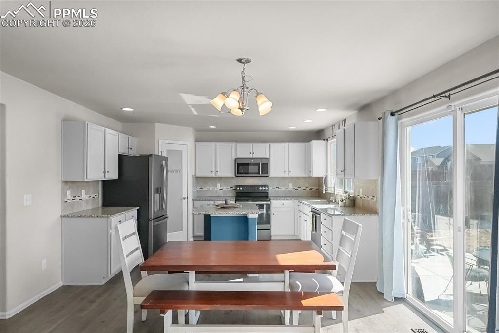 Image 9 of 25: Kitchen with granite countertops and pantry.