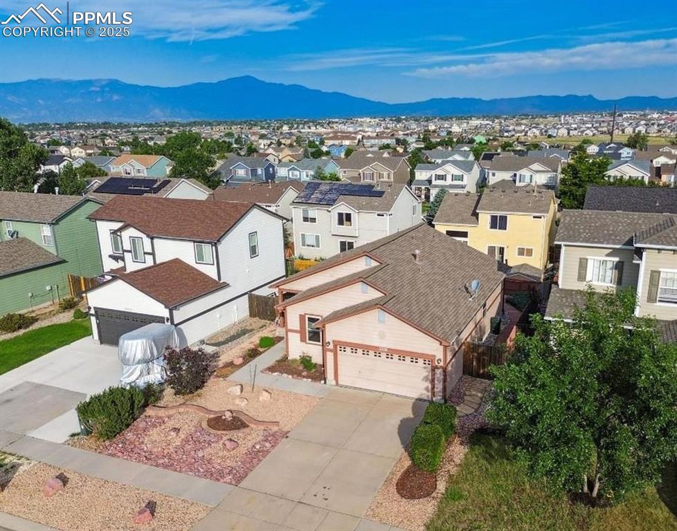 Caption: Aerial perspective of suburban area with mountains