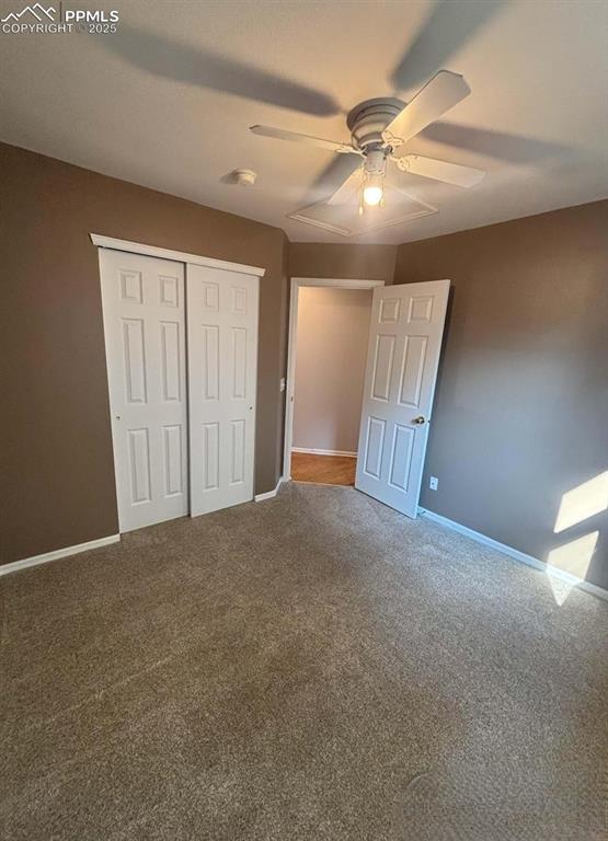 Image 12 of 18: Unfurnished bedroom featuring a closet, carpet, and a ceiling fan