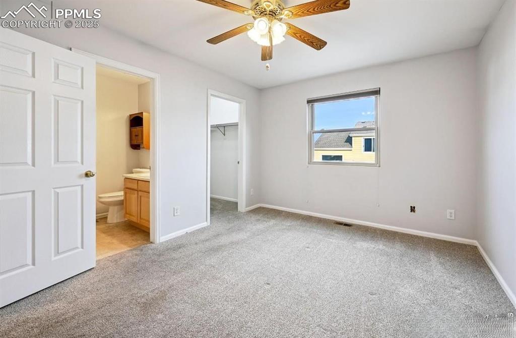 Image 13 of 18: Unfurnished bedroom featuring light colored carpet, a spacious closet, ceil