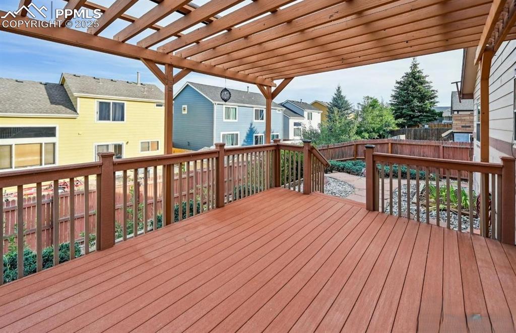 Image 15 of 18: Deck with a fenced backyard, a residential view, and a pergola