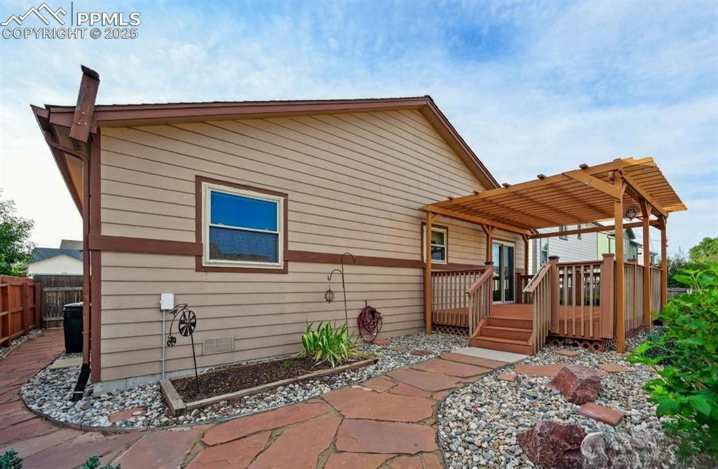 Image 16 of 18: Rear view of house featuring a wooden deck
