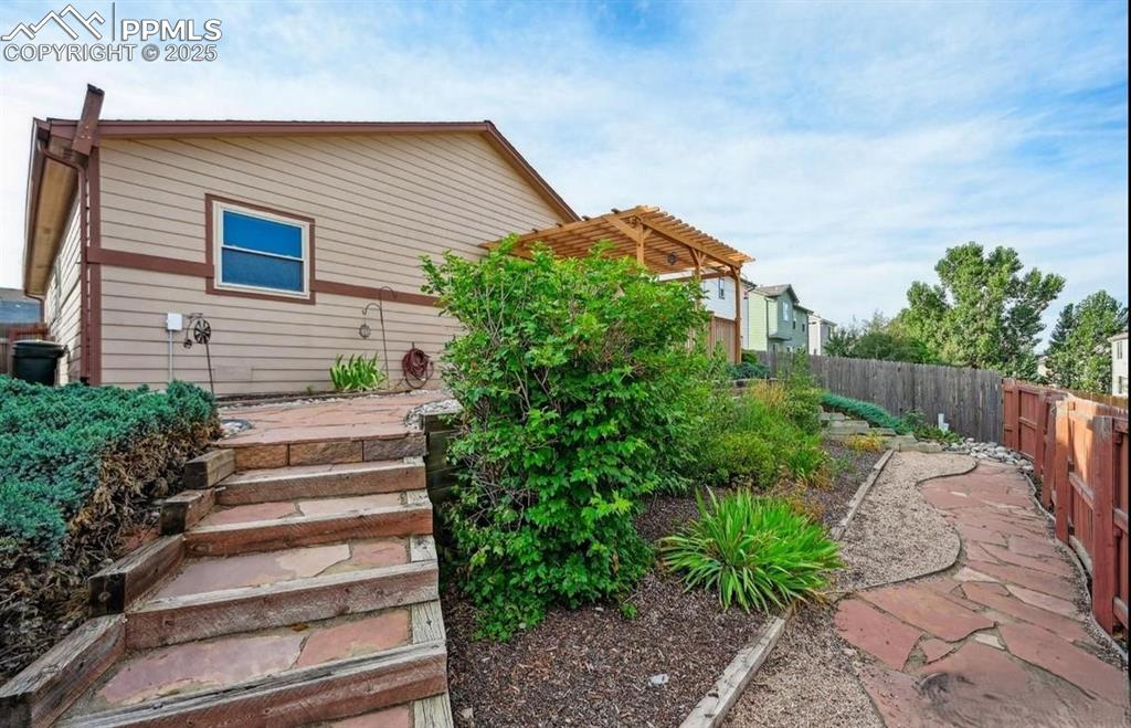 Image 17 of 18: View of property exterior with a fenced backyard and a patio