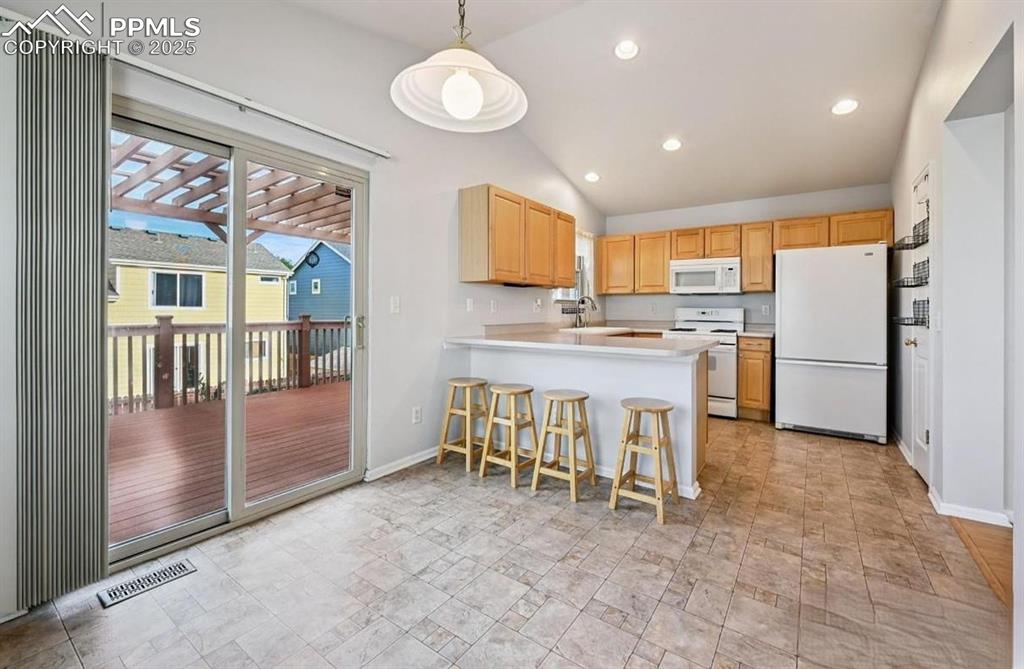 Image 7 of 18: Kitchen featuring light brown cabinetry, white appliances, light countertop