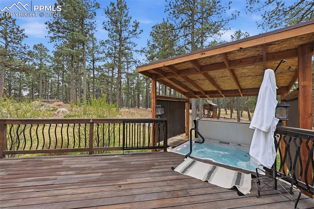 Image 34 of 50: Deck with covered hot tub