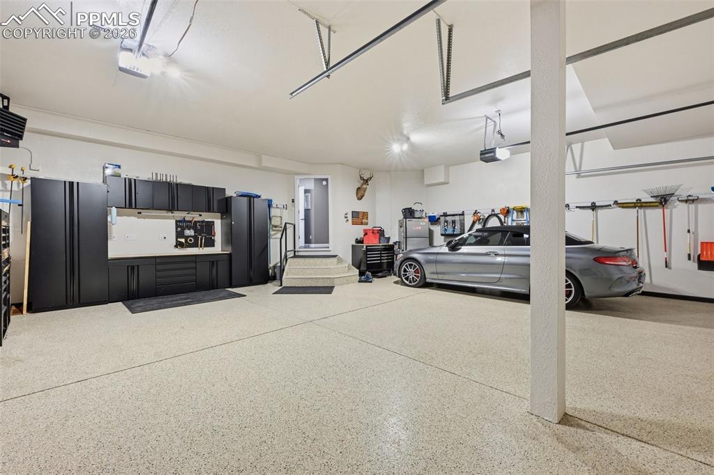 Image 36 of 50: Garage - features Epoxy flooring, heater and cabinets