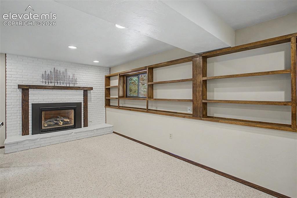 Image 30 of 49: 2nd Gas Fireplace with custom shelving