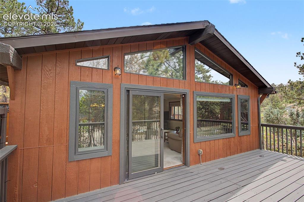 Image 36 of 49: Huge 25 x 12 Deck off living room expands the beautiful outdoors and living