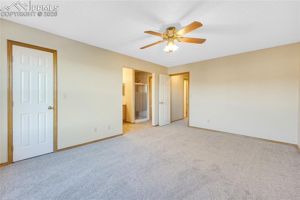 Image 13 of 32: Unfurnished bedroom featuring carpet floors, ceiling fan, and connected bat