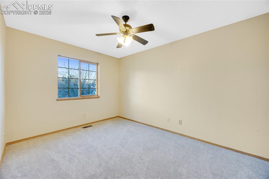 Image 18 of 32: Spare room with carpet floors and ceiling fan