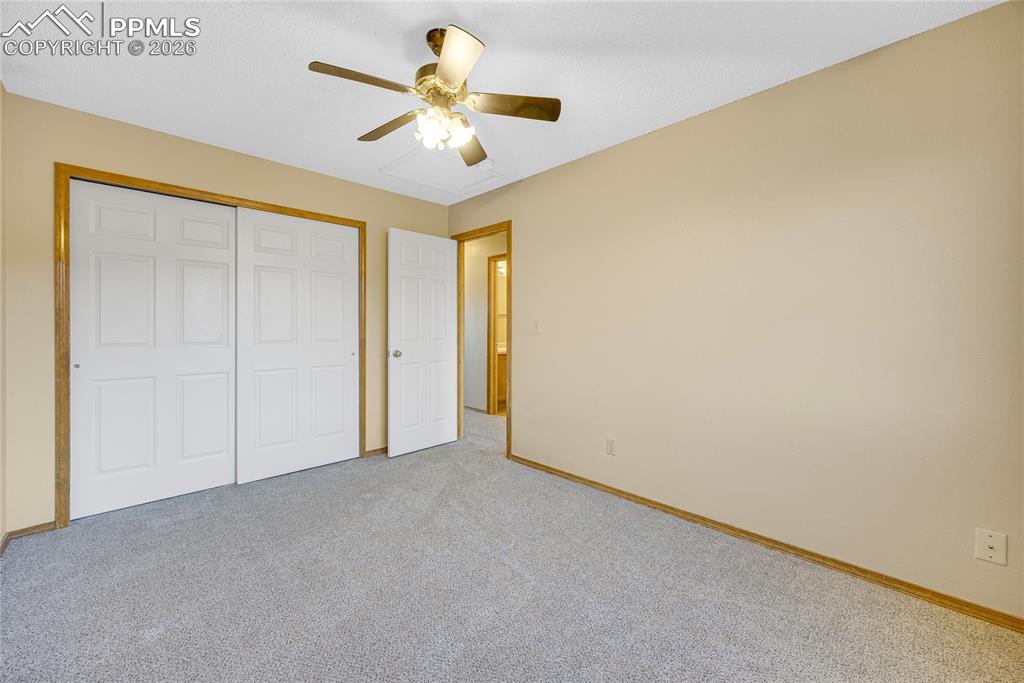 Image 19 of 32: Unfurnished bedroom featuring carpet floors, ceiling fan, and a closet