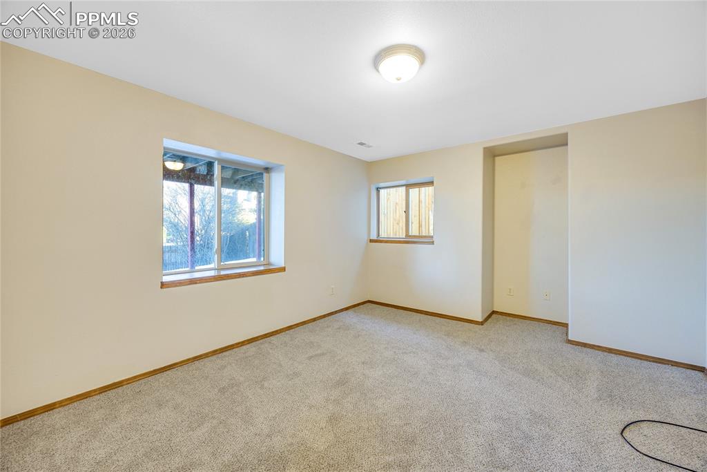 Image 23 of 32: Unfurnished bedroom with light colored carpet and a closet