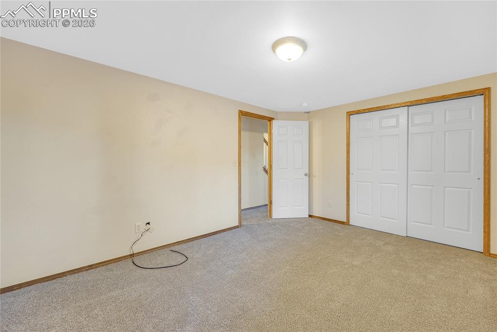 Image 24 of 32: Unfurnished bedroom with a closet and carpet floors