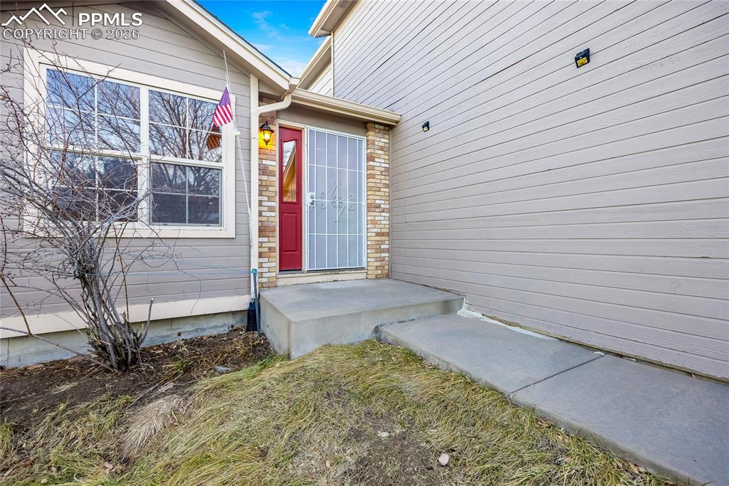 Image 3 of 32: Property entrance featuring brick siding