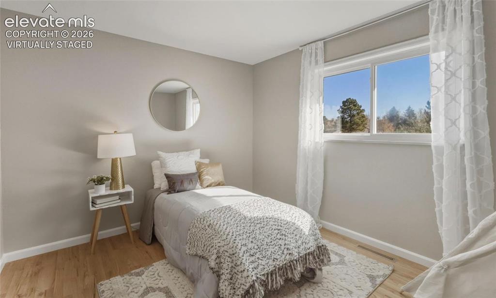 Image 18 of 32: 2nd main level bedroom virtually staged
